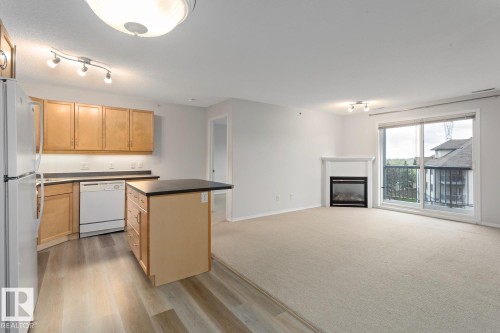 446 16311 95 Street, Edmonton, AB - Indoor Photo Showing Kitchen With Fireplace
