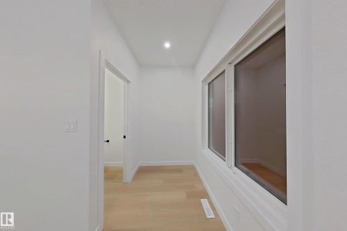 Hallway featuring light wood-type flooring and recessed lighting - 65 18120 28 Avenue, Edmonton, AB - Indoor Photo Showing Other Room