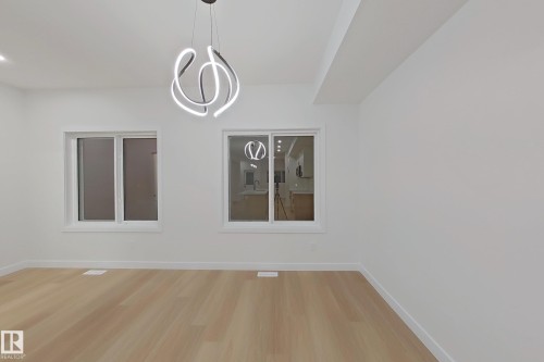 Unfurnished dining area featuring light wood-type flooring and baseboards - 65 18120 28 Avenue, Edmonton, AB - Indoor Photo Showing Other Room