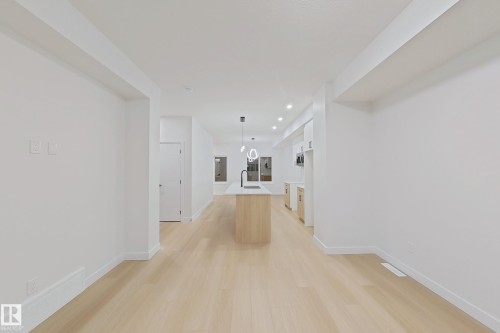 Hall with light wood finished floors and recessed lighting - 65 18120 28 Avenue, Edmonton, AB - Indoor Photo Showing Other Room