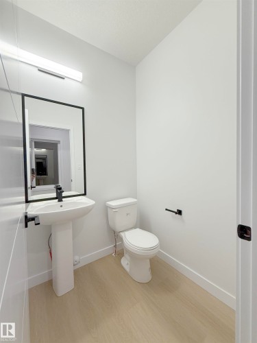 Half bathroom with light wood finished floors and baseboards - 65 18120 28 Avenue, Edmonton, AB - Indoor Photo Showing Bathroom