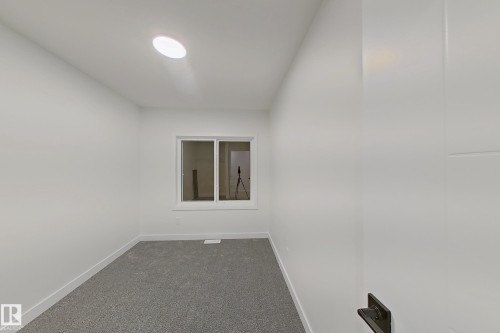 Carpeted spare room with baseboards - 65 18120 28 Avenue, Edmonton, AB - Indoor Photo Showing Other Room