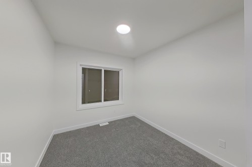 Carpeted spare room featuring baseboards - 65 18120 28 Avenue, Edmonton, AB - Indoor Photo Showing Other Room