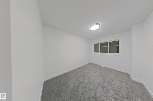 Carpeted empty room with baseboards - 65 18120 28 Avenue, Edmonton, AB - Indoor Photo Showing Other Room