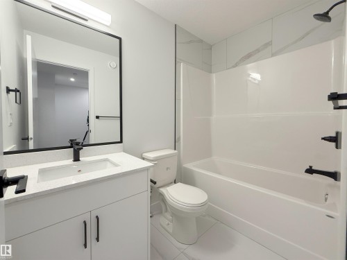 Full bathroom featuring shower / bath combination, vanity, and tile patterned flooring - 65 18120 28 Avenue, Edmonton, AB - Indoor Photo Showing Bathroom