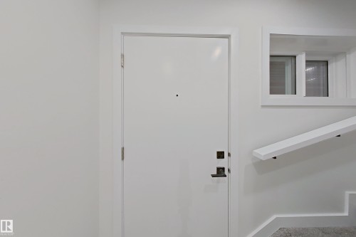 Doorway to outside featuring baseboards - 65 18120 28 Avenue, Edmonton, AB - Indoor Photo Showing Other Room