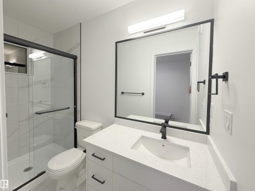 Full bath with vanity and a stall shower - 65 18120 28 Avenue, Edmonton, AB - Indoor Photo Showing Bathroom