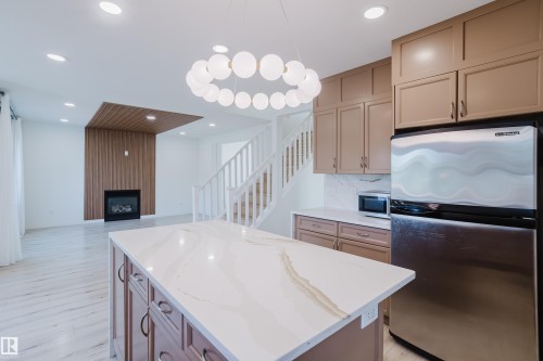 1665 Glastonbury Boulevard, Edmonton, AB - Indoor Photo Showing Kitchen With Fireplace