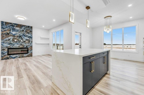 219 Crystal Creek Drive, Leduc, AB - Indoor Photo Showing Kitchen With Fireplace