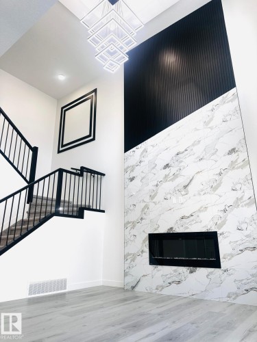 Detailed view of a fireplace and wood finished floors - 3906 41 Avenue, Beaumont, AB - Indoor With Fireplace