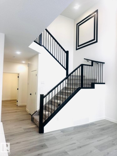 Stairs featuring wood finished floors and recessed lighting - 3906 41 Avenue, Beaumont, AB - Indoor Photo Showing Other Room