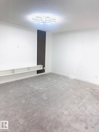 Carpeted empty room with baseboards - 3906 41 Avenue, Beaumont, AB - Indoor Photo Showing Other Room