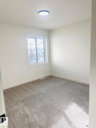 Carpeted empty room featuring baseboards - 3906 41 Avenue, Beaumont, AB - Indoor Photo Showing Other Room