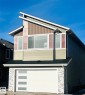 View of front of property featuring an attached garage and board and batten siding - 3906 41 Avenue, Beaumont, AB  - Outdoor 