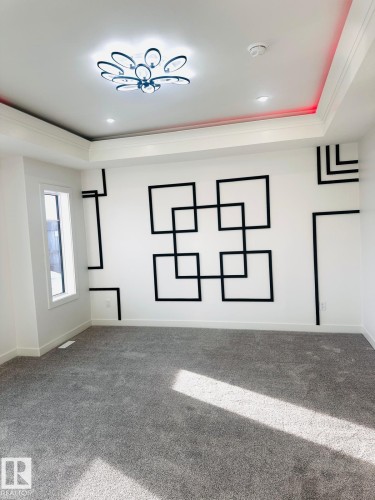 Carpeted spare room featuring crown molding, a raised ceiling, and recessed lighting - 3906 41 Avenue, Beaumont, AB - Indoor Photo Showing Other Room