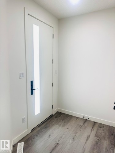 Entrance foyer with light wood-style floors and baseboards - 3906 41 Avenue, Beaumont, AB - Indoor Photo Showing Other Room