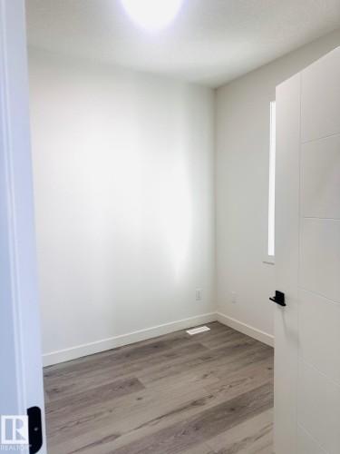 Spare room with light wood-style floors and baseboards - 3906 41 Avenue, Beaumont, AB - Indoor Photo Showing Other Room