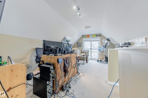 Massive bonus room with sloped ceilings & patio doors to a private balcony. This versatile space can serve many purposes including a family room, media space, huge office or can even be converted to a bedroom. - 1312 74 Street, Edmonton, AB - Indoor