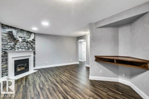 2812 40A Avenue, Edmonton, AB - Indoor Photo Showing Other Room With Fireplace