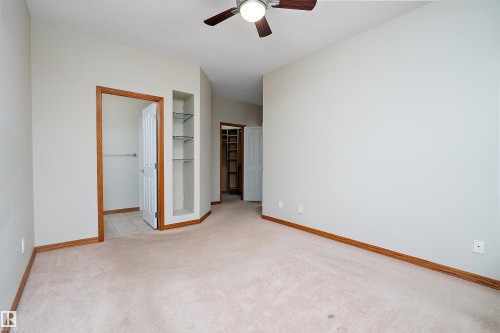 Unfurnished bedroom with a spacious closet, light colored carpet, and ceiling fan - 4931 48 Avenue, Onoway, AB - Indoor Photo Showing Other Room