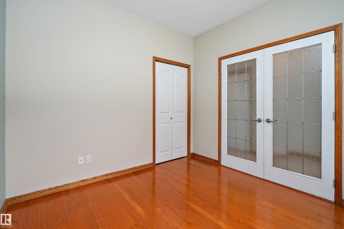 Unfurnished bedroom featuring french doors, light wood-style floors, and a closet - 4931 48 Avenue, Onoway, AB - Indoor Photo Showing Other Room