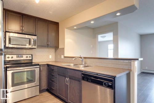 254 11517 Ellerslie Road, Edmonton, AB - Indoor Photo Showing Kitchen With Double Sink
