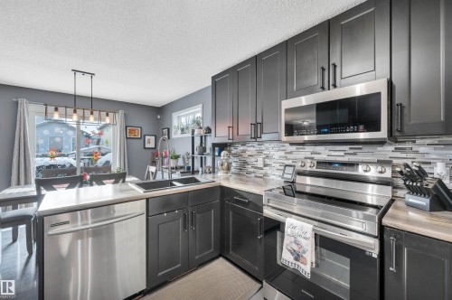 27 Douglas Crescent, Leduc, AB - Indoor Photo Showing Kitchen With Double Sink With Upgraded Kitchen