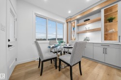 Dining area with light wood-style floors and recessed lighting - 