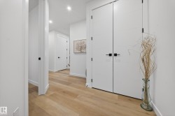 Hall with light wood-style floors and recessed lighting - 