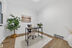 Office with a baseboard radiator and light wood finished floors - 