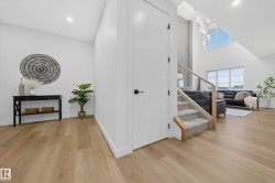 Stairway with wood finished floors and a towering ceiling - 