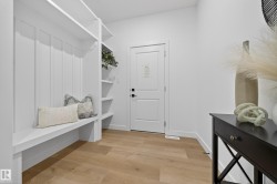 Mudroom featuring light wood-style flooring and baseboards - 