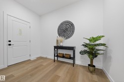 Foyer entrance featuring light wood-style floors and baseboards - 