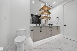 Bathroom with light marble finish flooring, double vanity, and recessed lighting - 