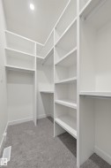 Walk in closet with light colored carpet - 