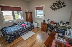 Bedroom featuring light wood-type flooring and an office area - 