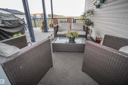 View of wooden balcony with an outdoor living space and a deck - 