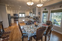 Dining area featuring light wood-style flooring, a textured ceiling, and recessed lighting - 