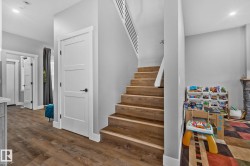 Stairs with recessed lighting and wood finished floors - 