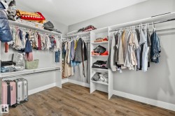 Walk in closet with light wood-style flooring - 