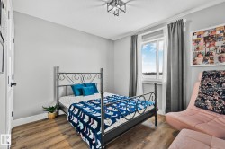 Bedroom with wood finished floors and a textured ceiling - 