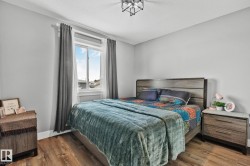Bedroom featuring dark wood-style floors and a textured ceiling - 