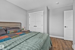 Bedroom featuring wood finished floors, a closet, and a textured ceiling - 