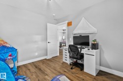 Office featuring a textured ceiling and wood finished floors - 