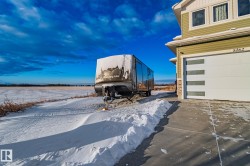 Snow covered garage with driveway - 
