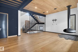 Foyer entrance featuring stairs, light wood finished floors, wood ceiling, and recessed lighting - 