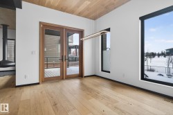 Unfurnished room featuring french doors, wood ceiling, and light wood finished floors - 