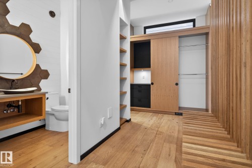 Spacious closet featuring light wood-style floors and a sink - 104 Edgewater Circle, Leduc, AB - Indoor Photo Showing Other Room