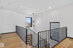 Corridor with an upstairs landing, light wood-style flooring, and recessed lighting - 