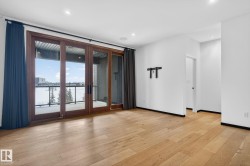 Empty room featuring a water view, light wood-style flooring, and recessed lighting - 
